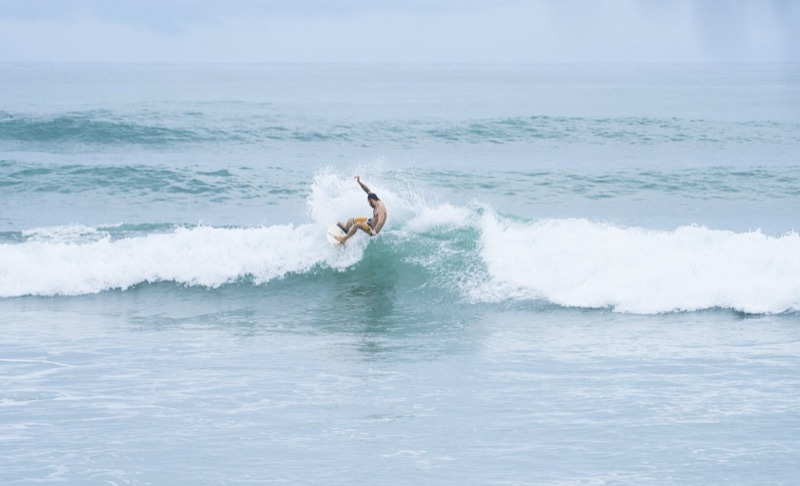 A surfer riding a wave at Playa Carmen
